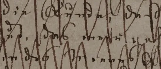 Close-up of dense brown cursive handwriting with tall looping strokes on grey-beige paper