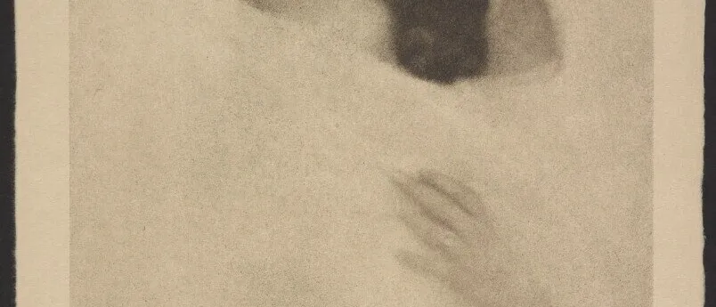 Soft-focus sepia print of a woman in a wide-brimmed hat, eyes closed, one hand at her shoulder, on a cream mount
